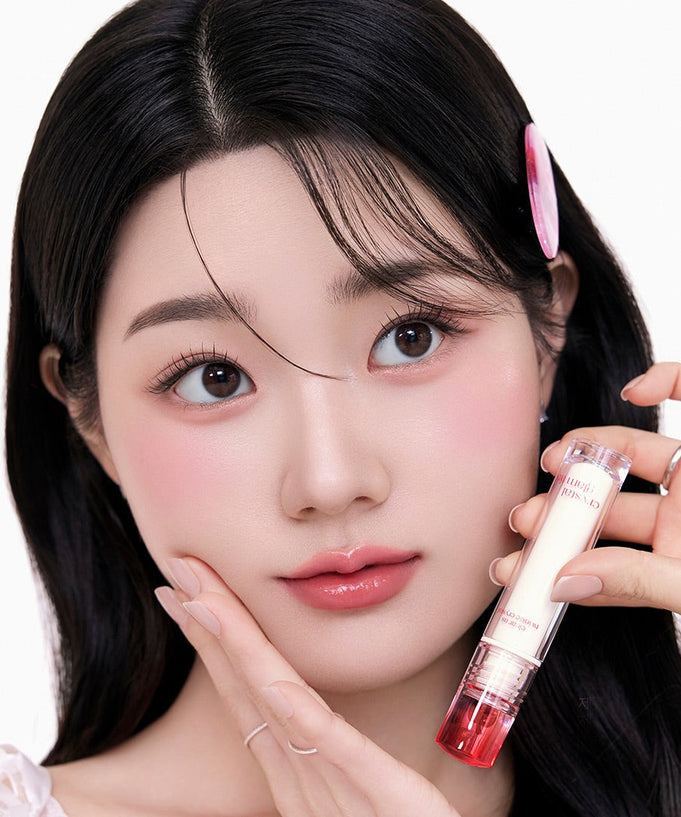 Woman holding CLIO Crystal Glam Tint with a youthful glow.
