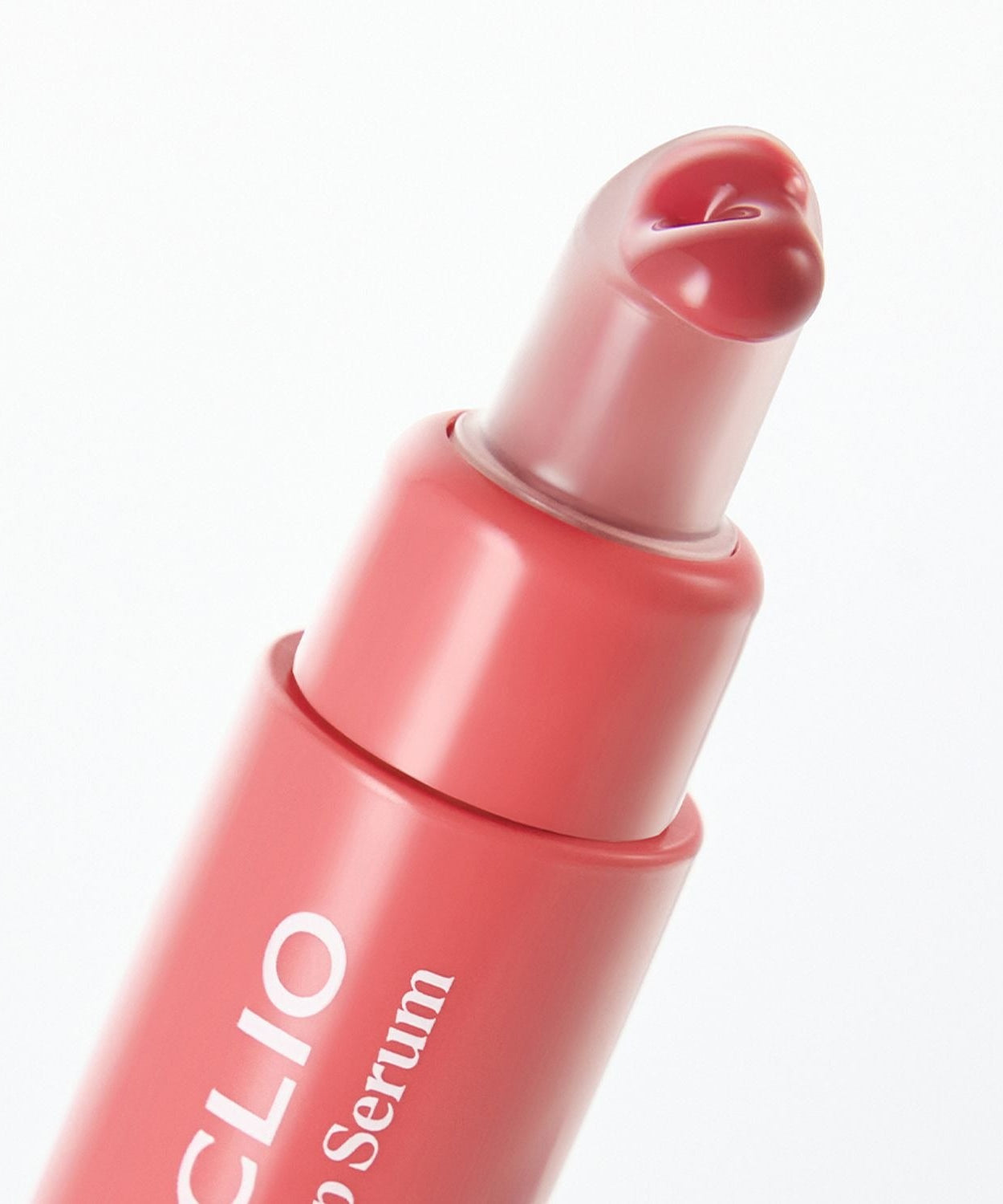 Close-up of the pink CLIO Glaze Lip Serum tube with heart-shaped applicator.