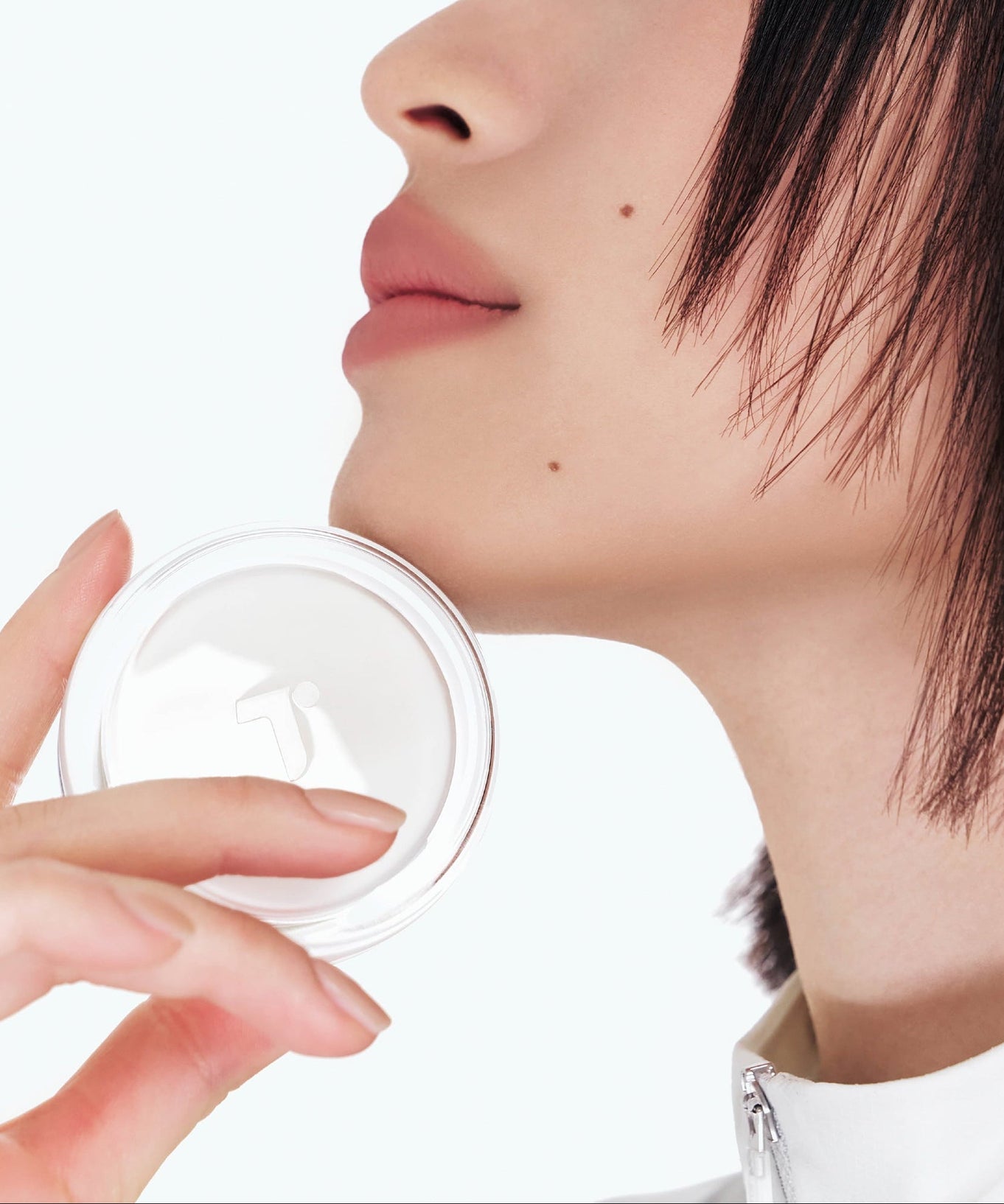 Person holding TENSE Hybrid Makeup Saver near face with close-up profile view.