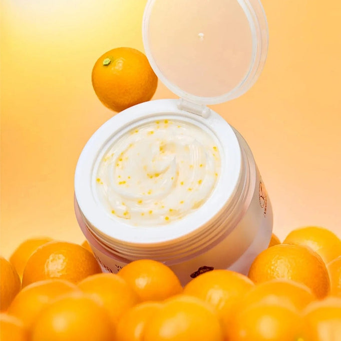 Open jar of D'ALBA Vita Toning Capsule Cream Complex 55g surrounded by fresh oranges on a vibrant background