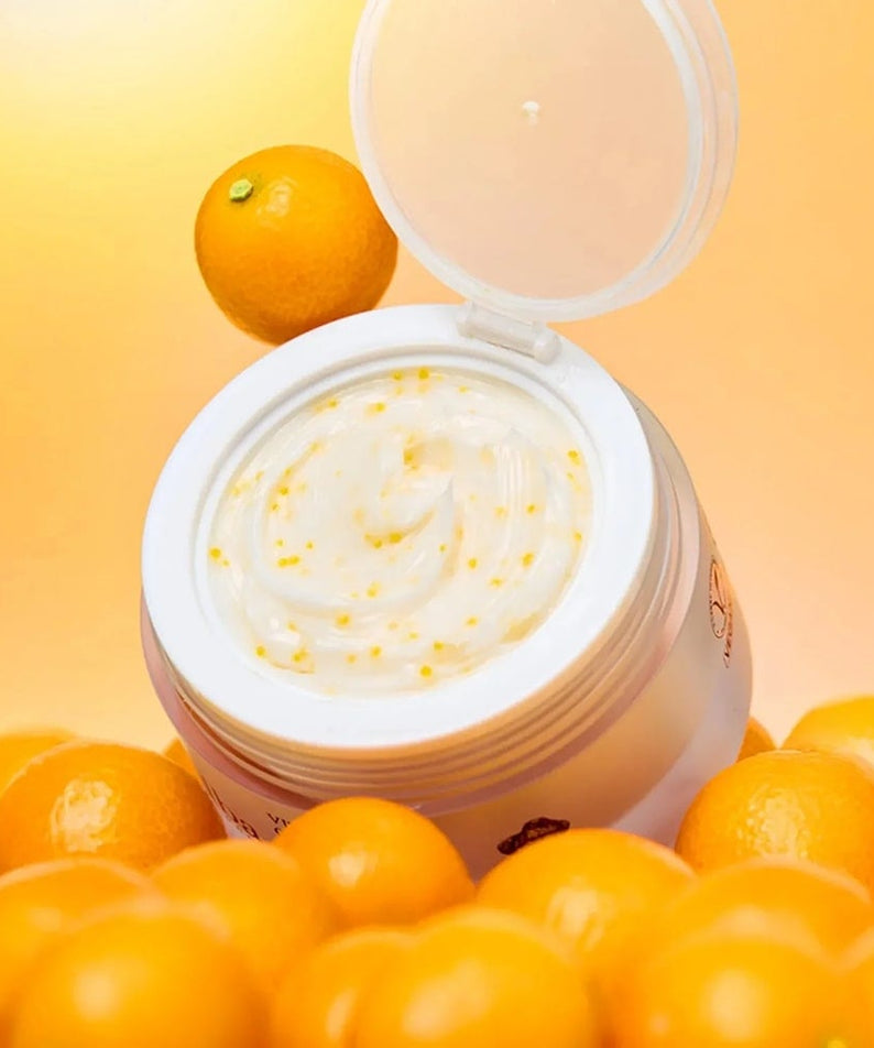Open jar of D'ALBA Vita Toning Capsule Cream Complex 55g surrounded by fresh oranges on a vibrant background