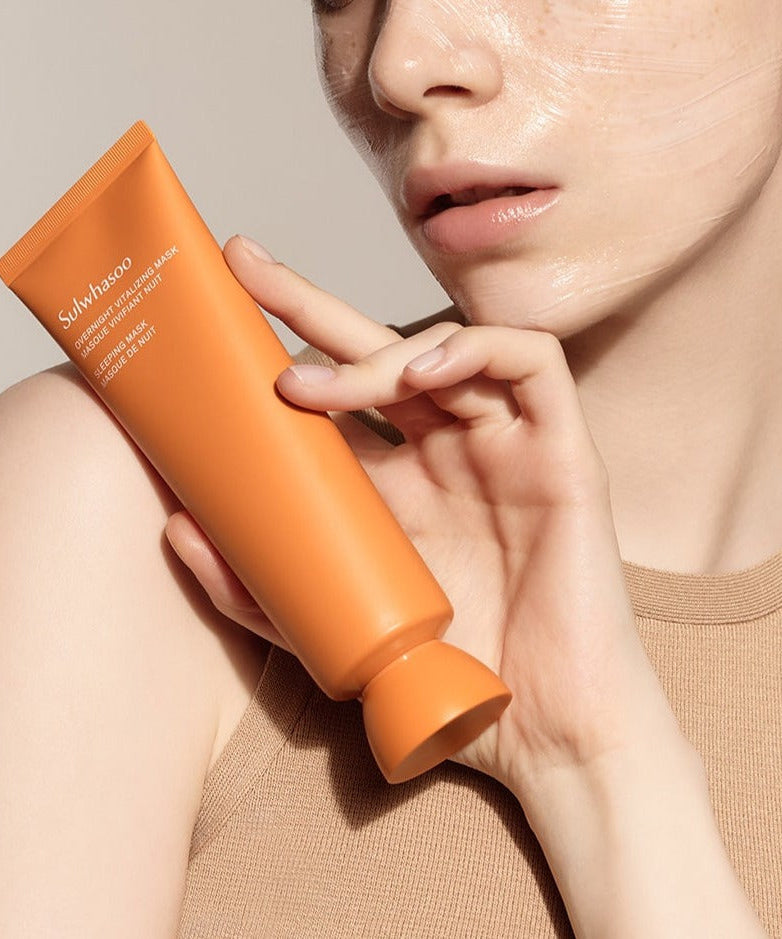 Woman holding SULWHASOO Overnight Vitalizing Sleeping Mask 120ml, a Korean skincare product for hydrating and nourishing the skin.