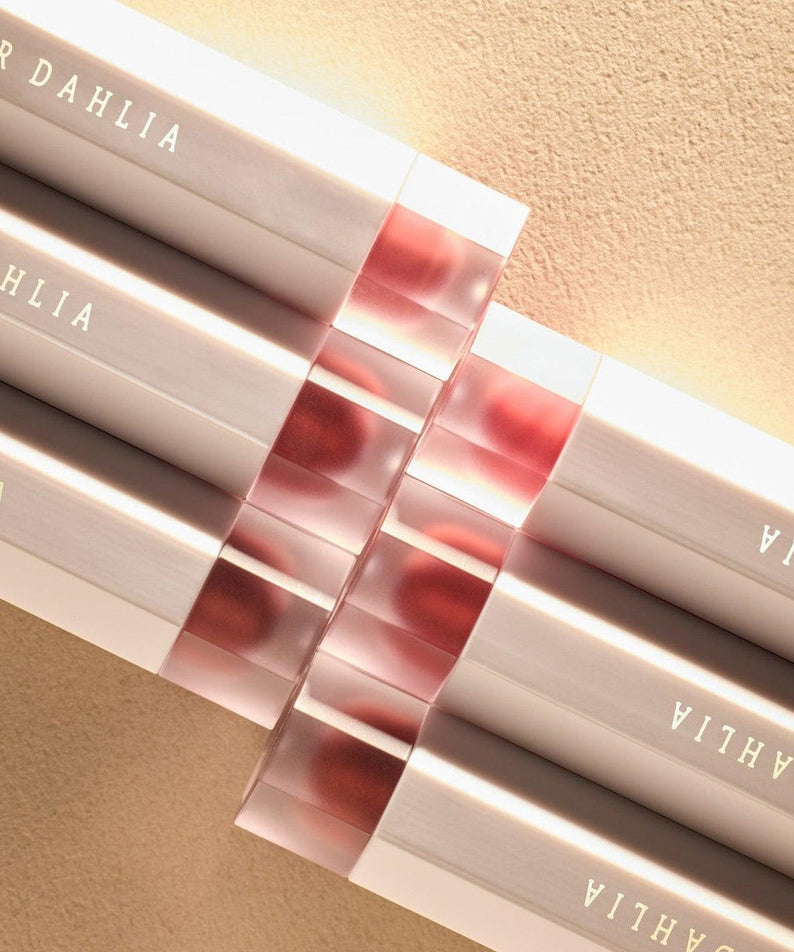DEAR DAHLIA Dream velvet Lip Cloud lipsticks arranged in a row on a soft beige background