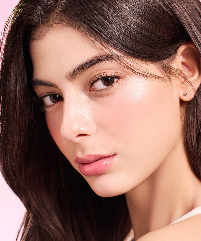 Model wearing DEAR DAHLIA Lip Paradise Sensual Lip Glow with a natural makeup look