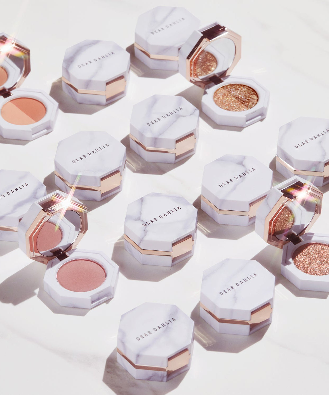 DEAR DAHLIA Paradise Dual Palette with various makeup shades in elegant marble packaging.