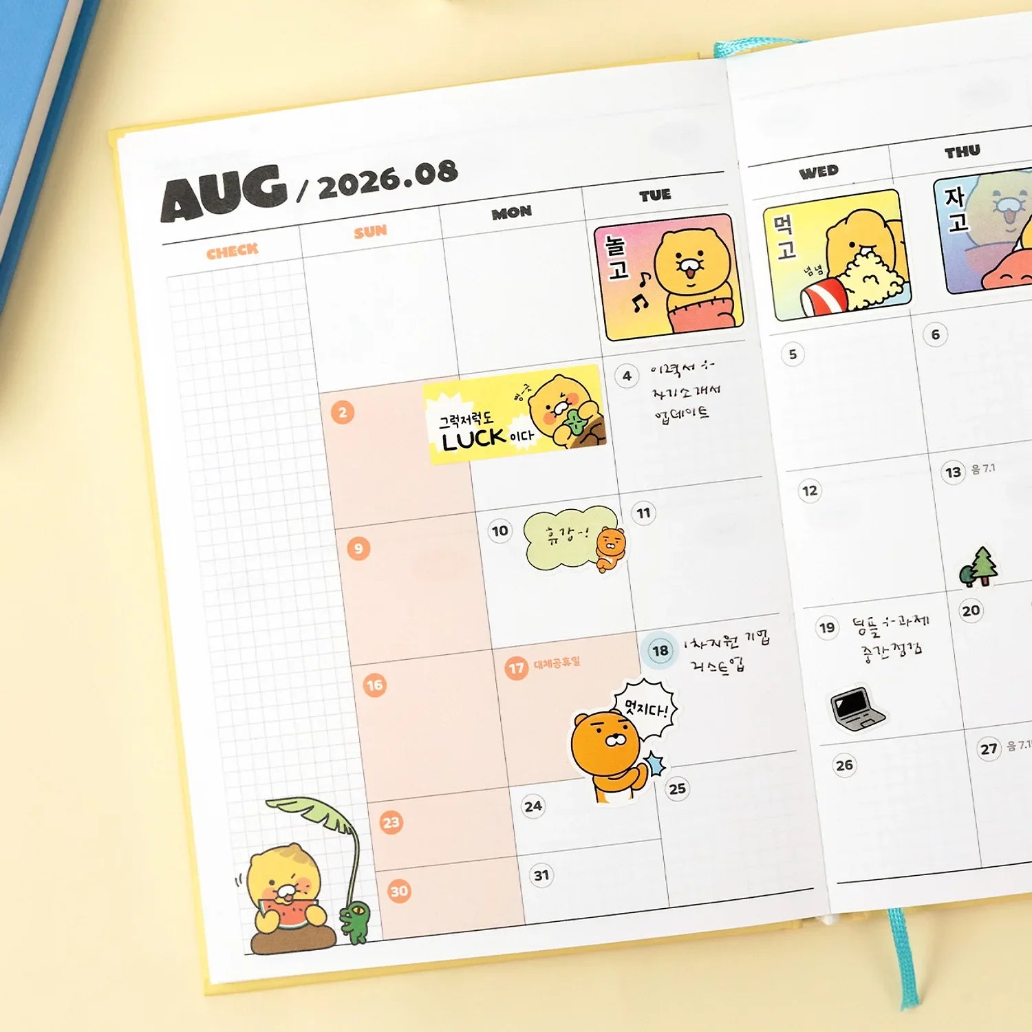 KAKAO FRIENDS Planner 2026 open on August calendar with character illustrations and colorful design.