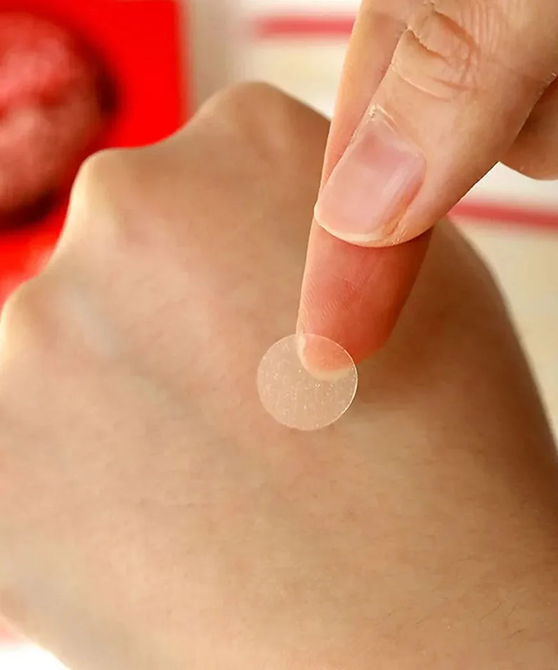 Close-up of a hand picking up ELIZAVECCA Witch Piggy Hell-Pore Blemish Spot Patch 44 EA for skincare use.