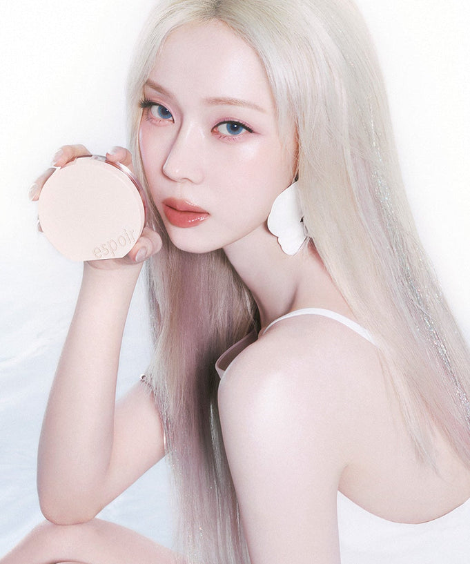 Model holding ESPOIR BE GLOW VOLUME CUSHION SPF42 PA+++ with radiant skin, emphasizing the product's glow-enhancing properties.