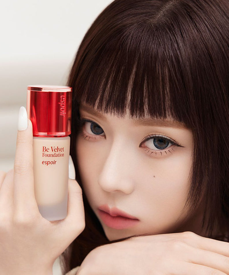 Woman holding ESPOIR BE VELVET FOUNDATION SPF22 PA++ bottle