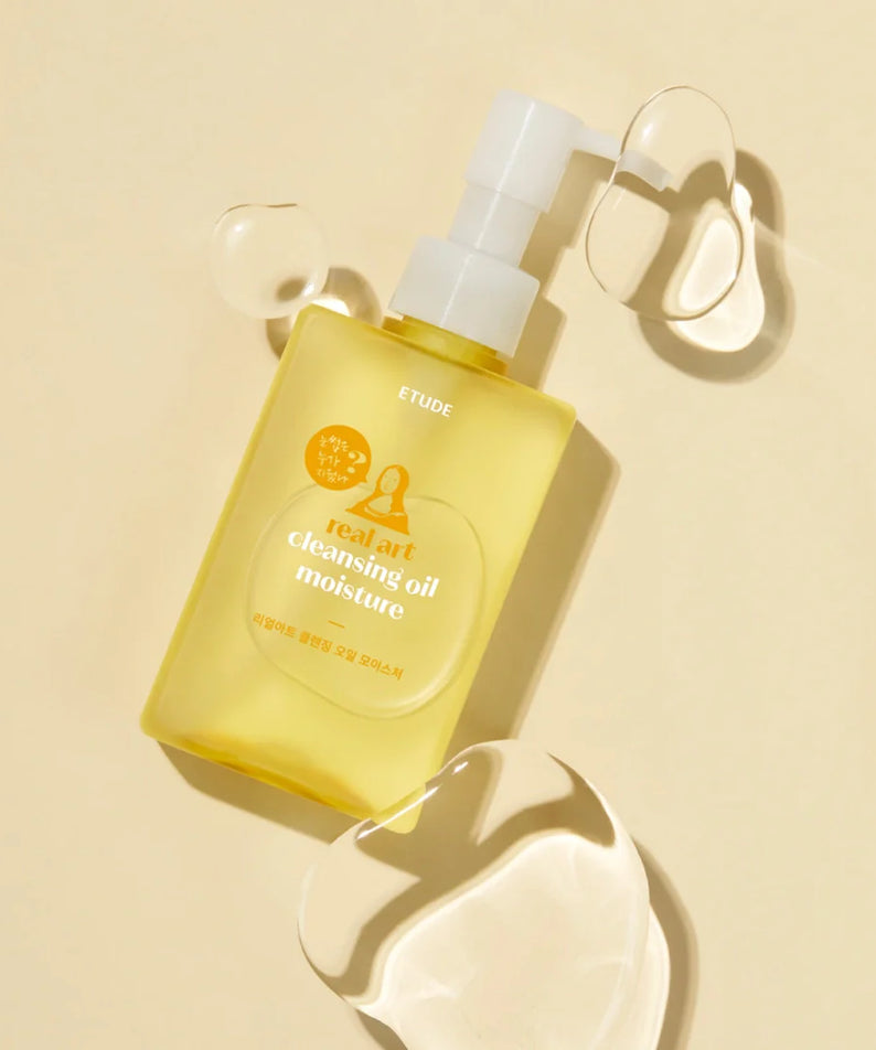 ETUDE Real Art Cleansing Oil Moisture 2-piece set (185ml+185ml) with oil spills on beige background