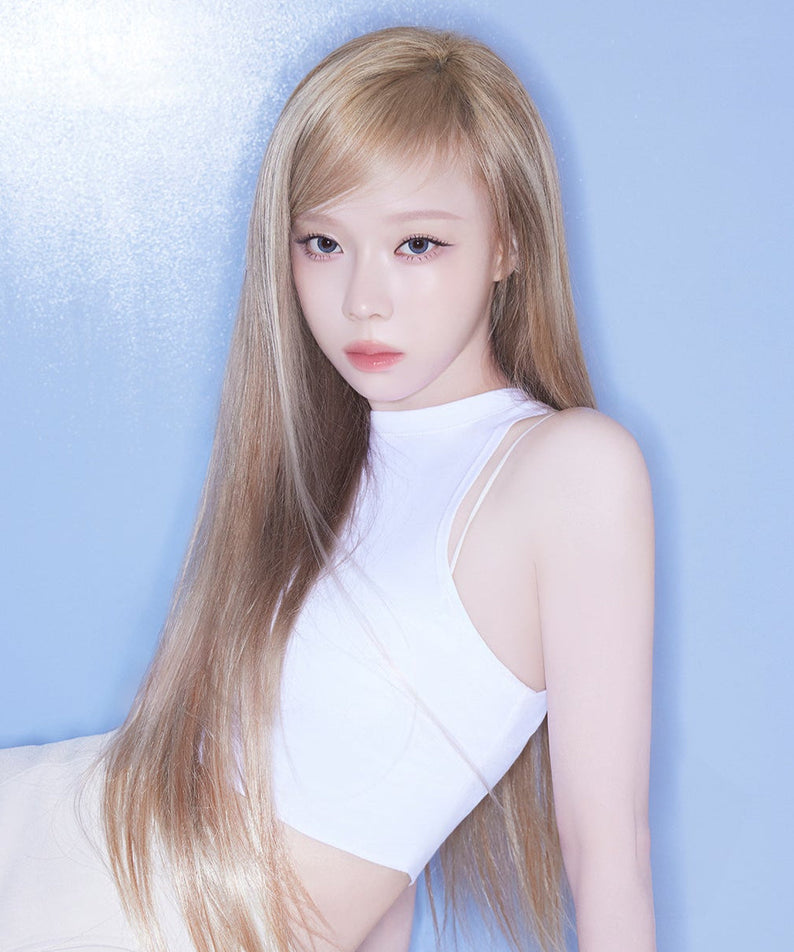 Stylish woman posing in a white top against a blue background