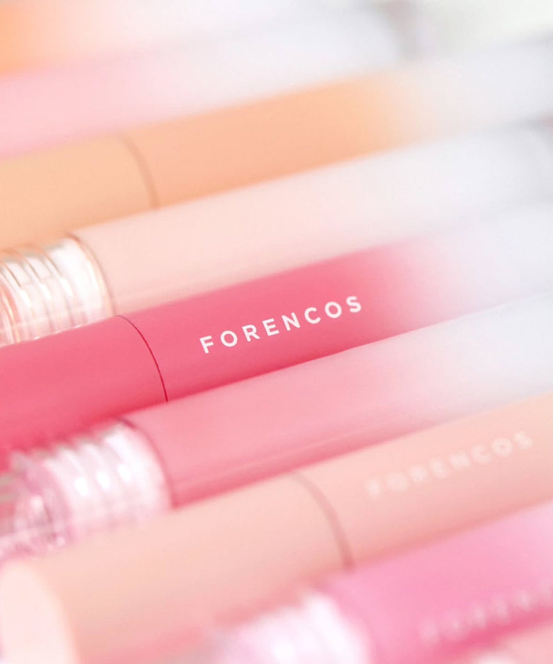 Assorted shades of FORENCOS All Light Mood Glow Tint tubes for vibrant lip color.