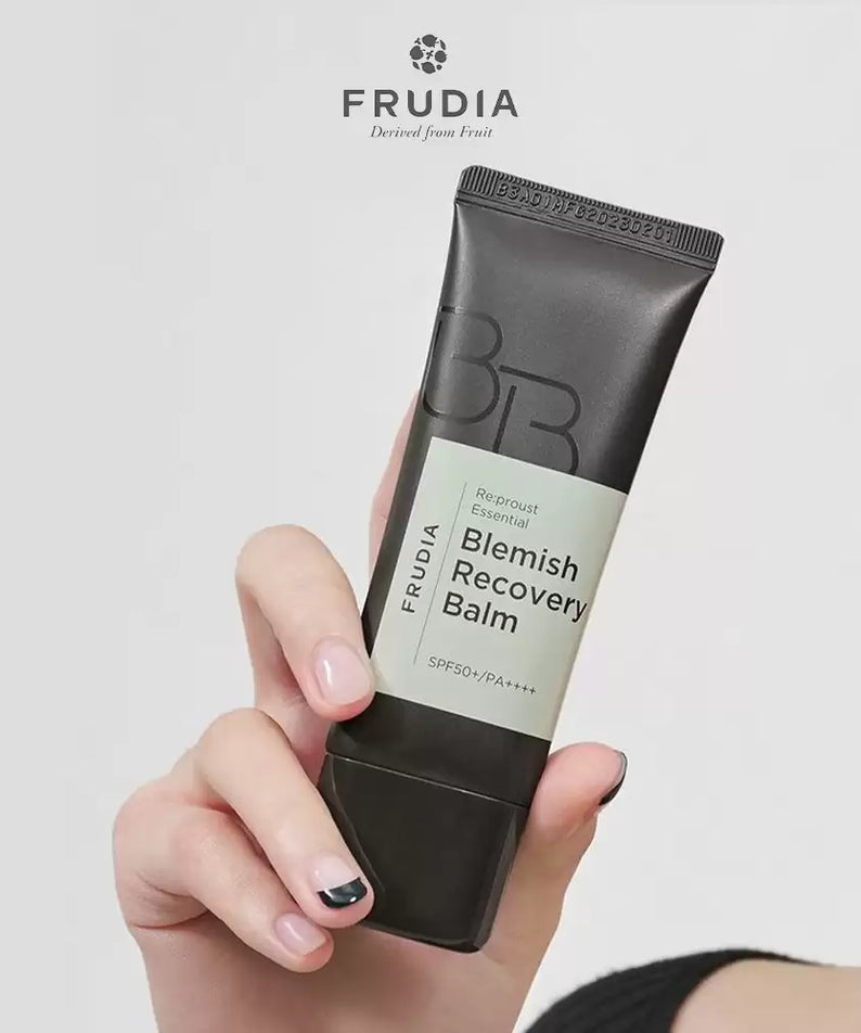 Hand holding FRUDIA Leafrust Essential Blemish Recovery Balm 40g tube