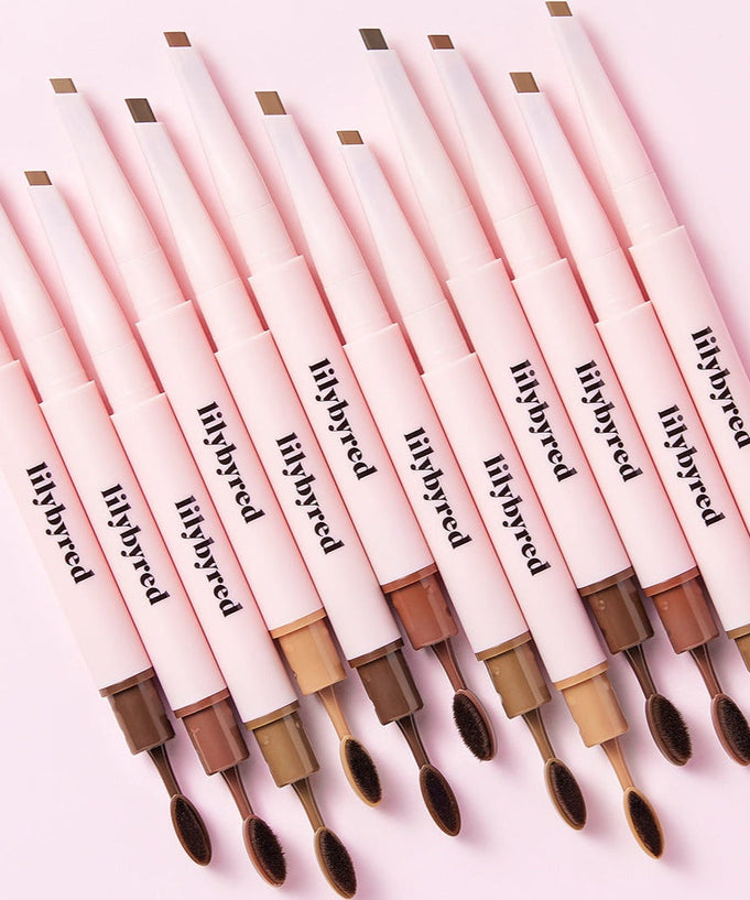 Array of LILYBYRED Hard Flat Brow Pencil in various shades with dual-ended design on a pink background.