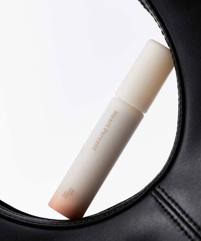 HEART PERCENT Dot On Mood All Cover Lip Base displayed creatively with a black leather frame.