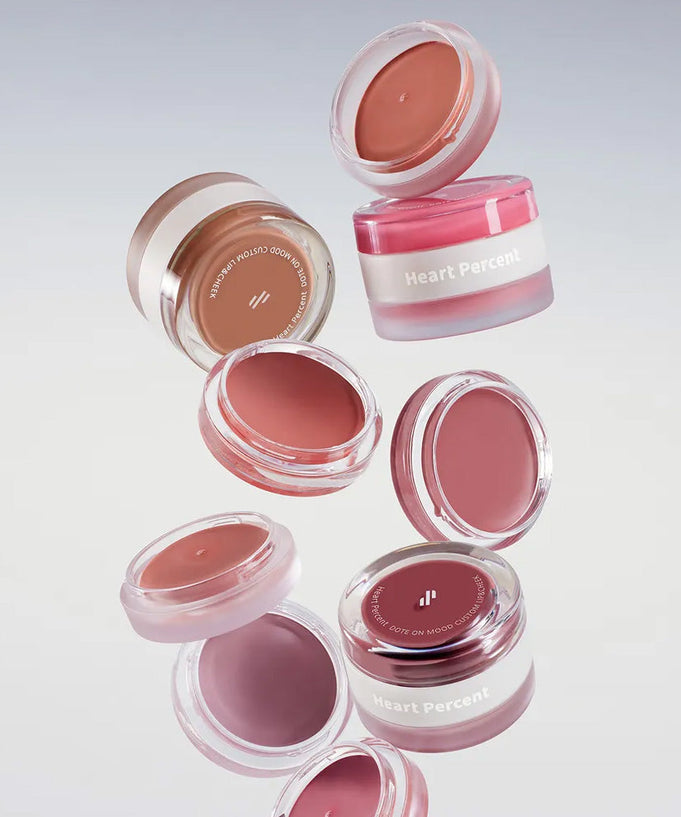 HEART PERCENT Dot On Mood Custom Lip & Cheek product containers floating against a neutral background.