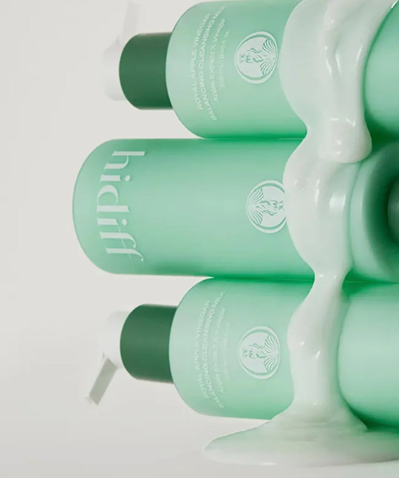 Image of HIDIFF Royal Apple Vinegar Balancing Cleansing Milk 250ml bottles with cleansing milk flowing over.