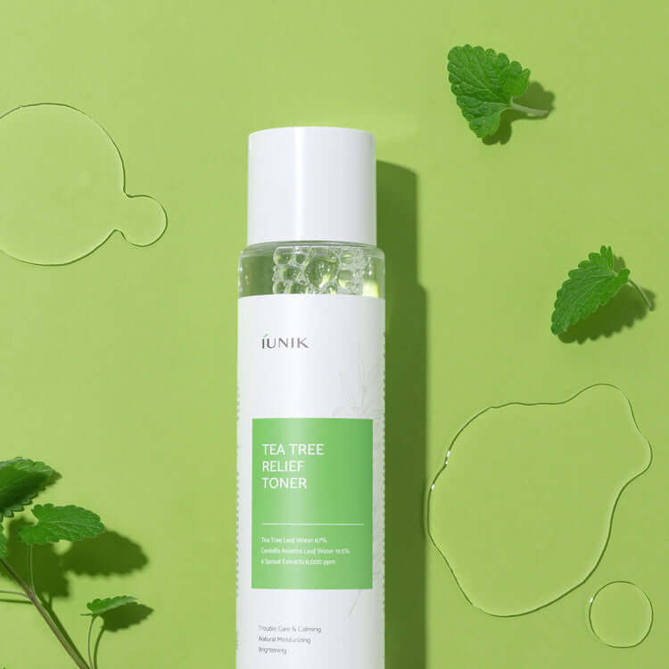 iUNIK Tea Tree Relief Toner 200ml on a green background with tea leaves
