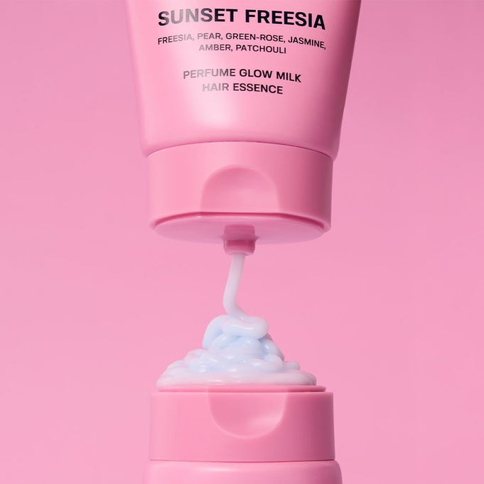 JULYME Perfume Glow Milk Hair Essence 80ml (Sunset Freesia) in pink bottle with creamy texture, perfect for luxurious hair care.