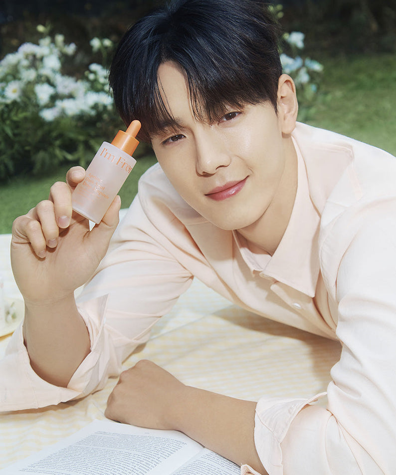 Man holding I'M FROM Apricot Dark Spot Drop Ampoule 50ml outdoors