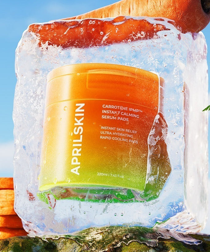 APRILSKIN Carrotene IPMP Calming Pad encased in ice with carrots and greenery, highlighting cooling and calming skincare benefits