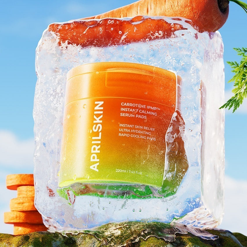 APRILSKIN Carrotene IPMP Calming Pad encased in ice with carrots and greenery, highlighting cooling and calming skincare benefits