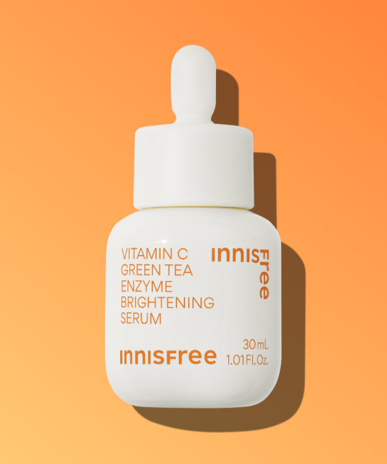 INNISFREE Vitamin C Green Tea Enzyme Brightening Serum bottle on orange background