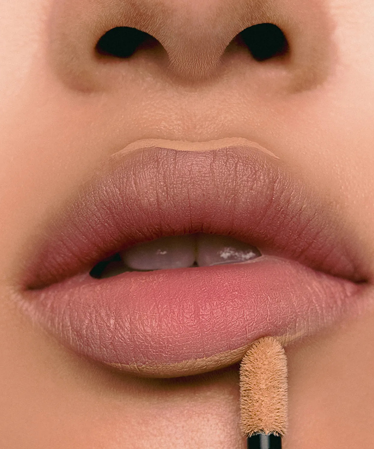 Close-up of lips applying JAVIN DE SEOUL Wink Lip Shade Primer for a smooth finish.