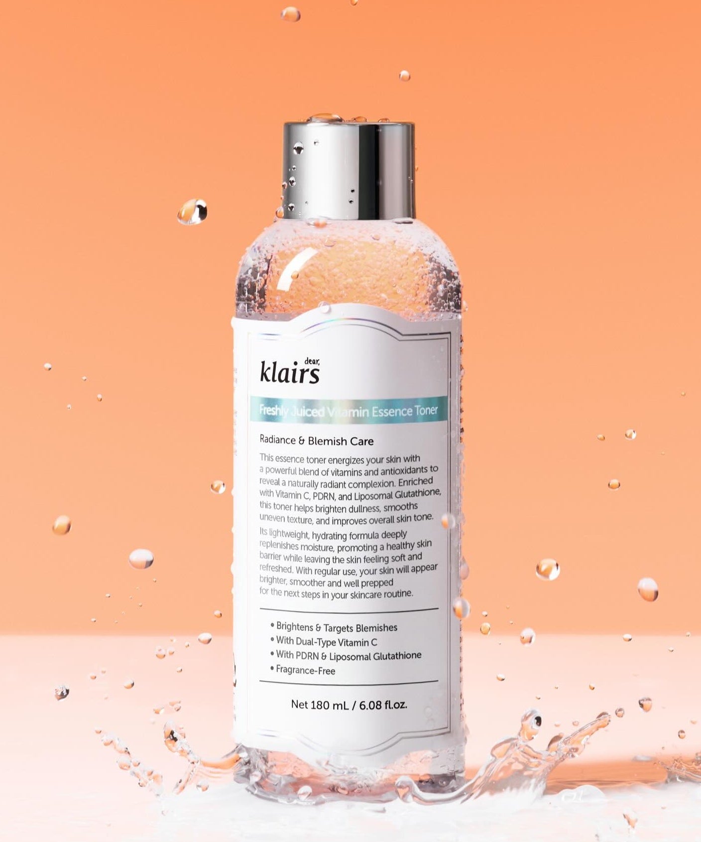 KLAIRS Freshly Juiced Vitamin Blemish Toner 180ml bottle against orange background