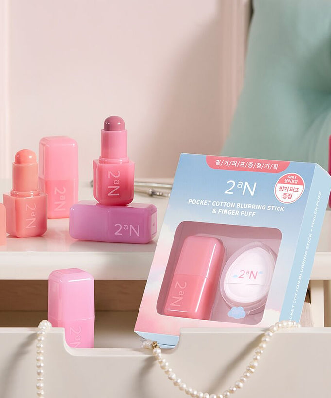 2an Pocket Cotton Blurring Stick displayed on a vanity table with packaging and multiple shades of product visible.