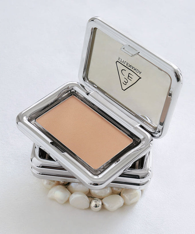 3CE New Take Face Blusher in sleek metallic compact, open to show peach shade against white background with decorative pearls.