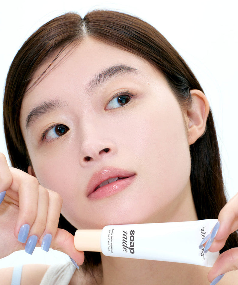Person holding ALTERNATIVE STEREO Soap Nude Milky Tone-Up Base SPF30 PA++, showcasing product texture and packaging.