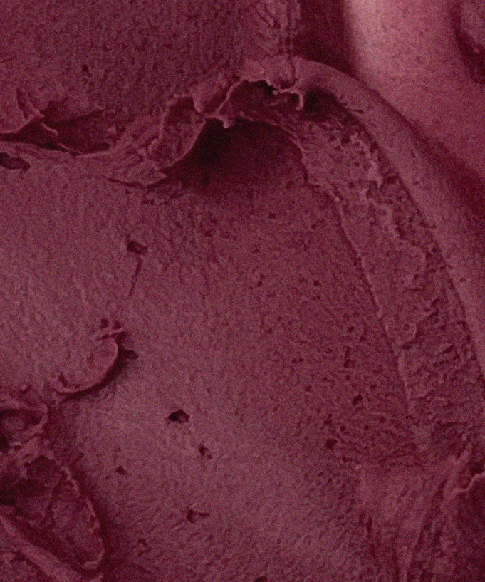 Close-up of AOU Floofy Matte Balm texture in rich burgundy shade.