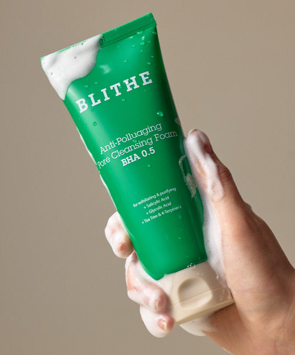 BLITHE Anti-Pollution Aging Pore Cleansing Foam BHA 0.5 150ml in hand lathered with foam, highlighting skincare benefits.