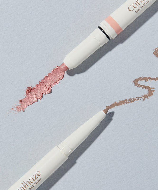 CORALHAZE Idol Aegyo Sal Maker beauty product with two shades of makeup on a light background.