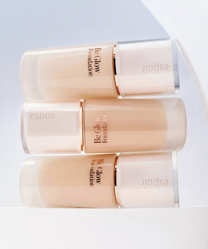 ESPOIR BE GLOW FOUNDATION SPF27 PA++ bottles in a stylish display on a white backdrop.