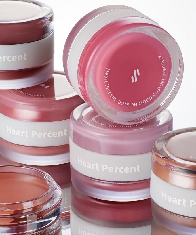 Various shades of HEART PERCENT Dot On Mood Custom Lip & Cheek products in jars