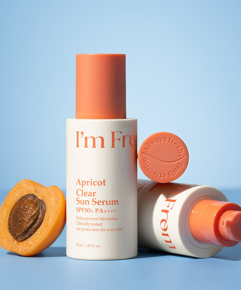 I'M FROM Apricot Clear Sun Serum 50ml with apricot slice and bottle on blue background.