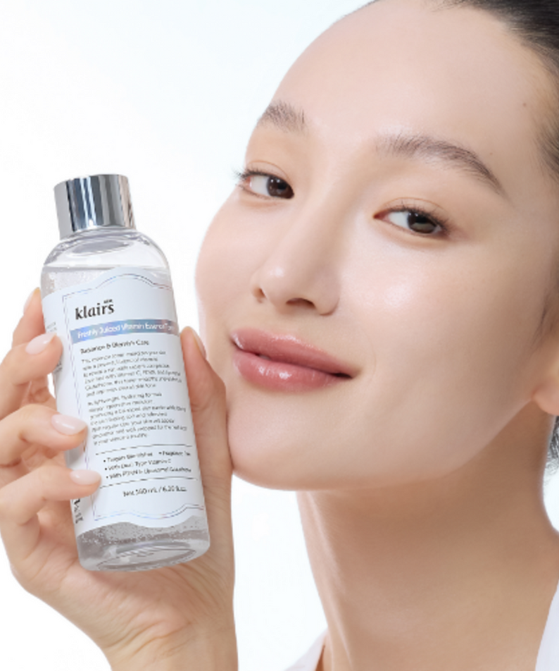 KLAIRS Freshly Juiced Vitamin Blemish Toner 180ml bottle held by smiling person.