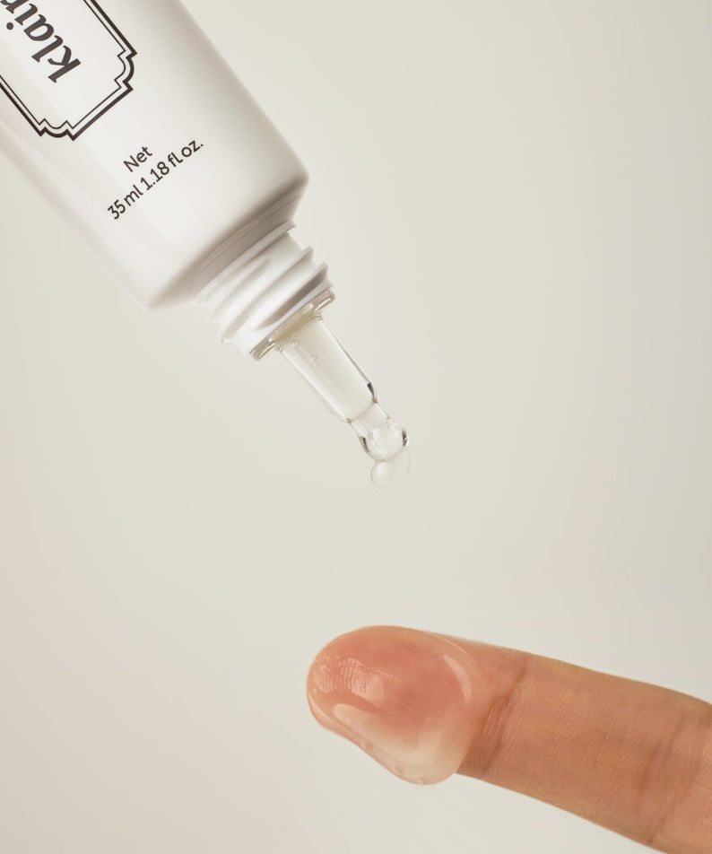 Applying KLAIRS Fundamental Eye Awakening Gel 35ml to fingertip from the tube.
