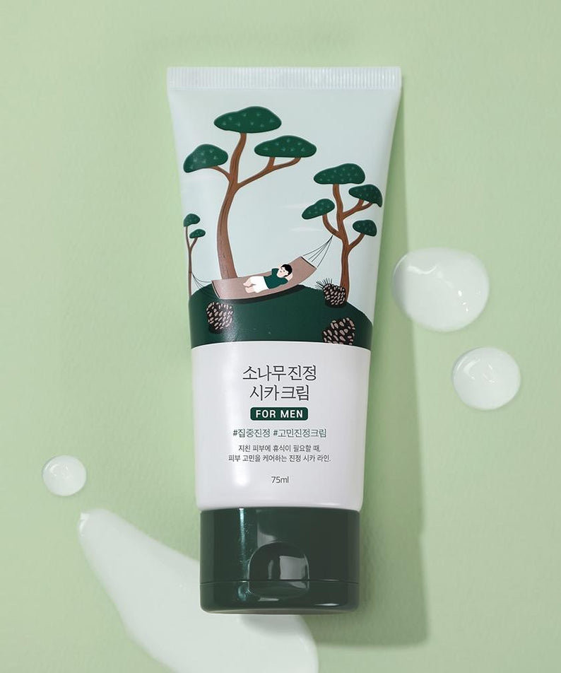 ROUND LAB For Men Pine Calming Cica Cream 75ml tube on green background with cream drops, Gentleman Korea men's soothing skincare product