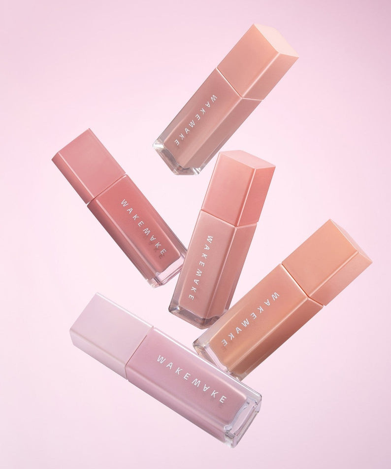 WAKE MAKE Sheer Glow Liquid Blusher 7g collection in various shades against pink background