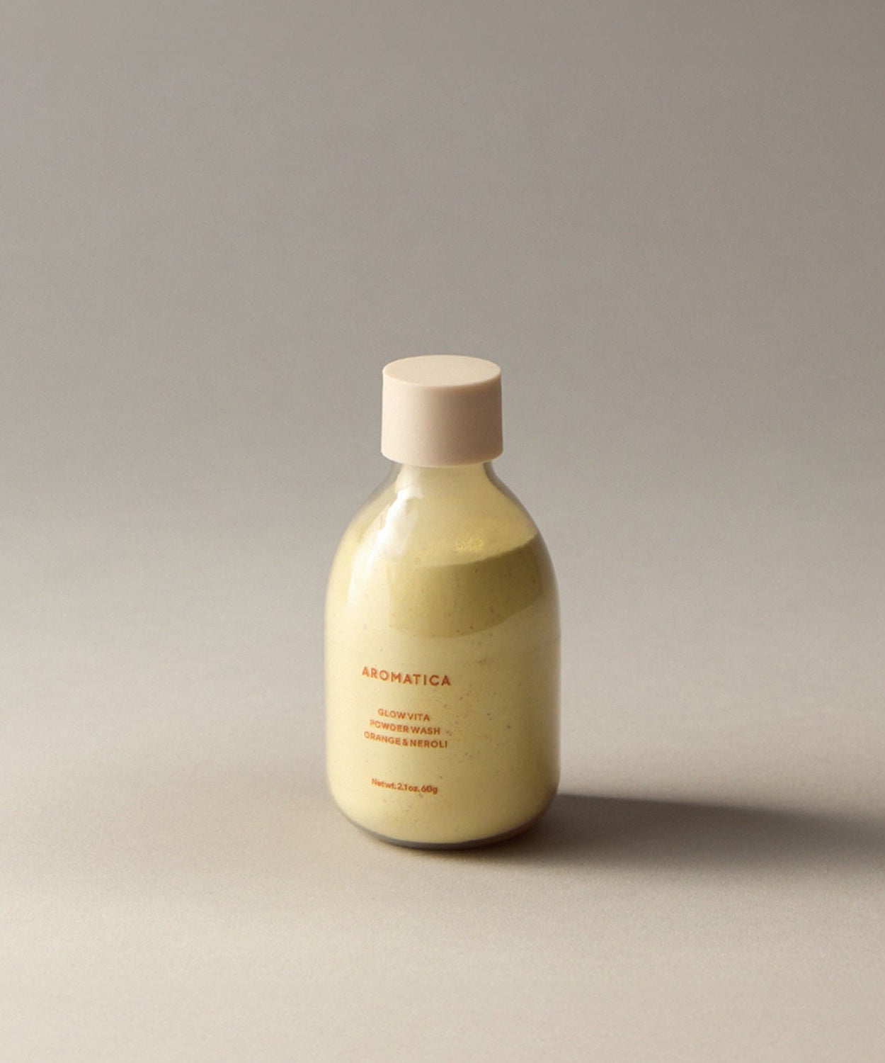 AROMATICA Glow Vita Powder Wash Orange & Neroli 60G in a sleek bottle on a neutral background