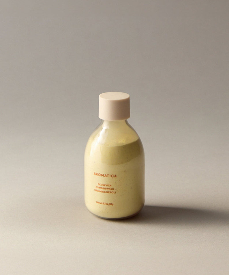 AROMATICA Glow Vita Powder Wash Orange & Neroli 60G in a sleek bottle on a neutral background