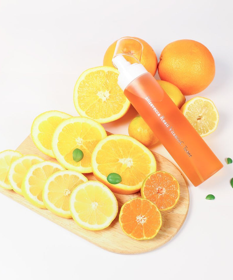 ELIZAVECCA Real One Vitamin C Toner 200ml bottle with citrus fruits on wooden board, promoting freshness and skincare benefits