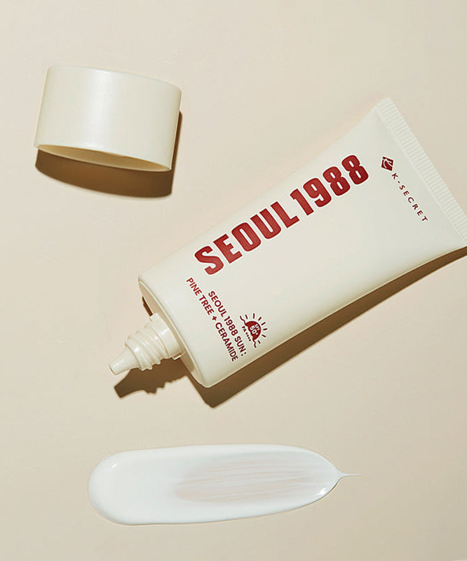 SEOUL 1988 Pine Sunscreen tube with cap and lotion smear on beige background