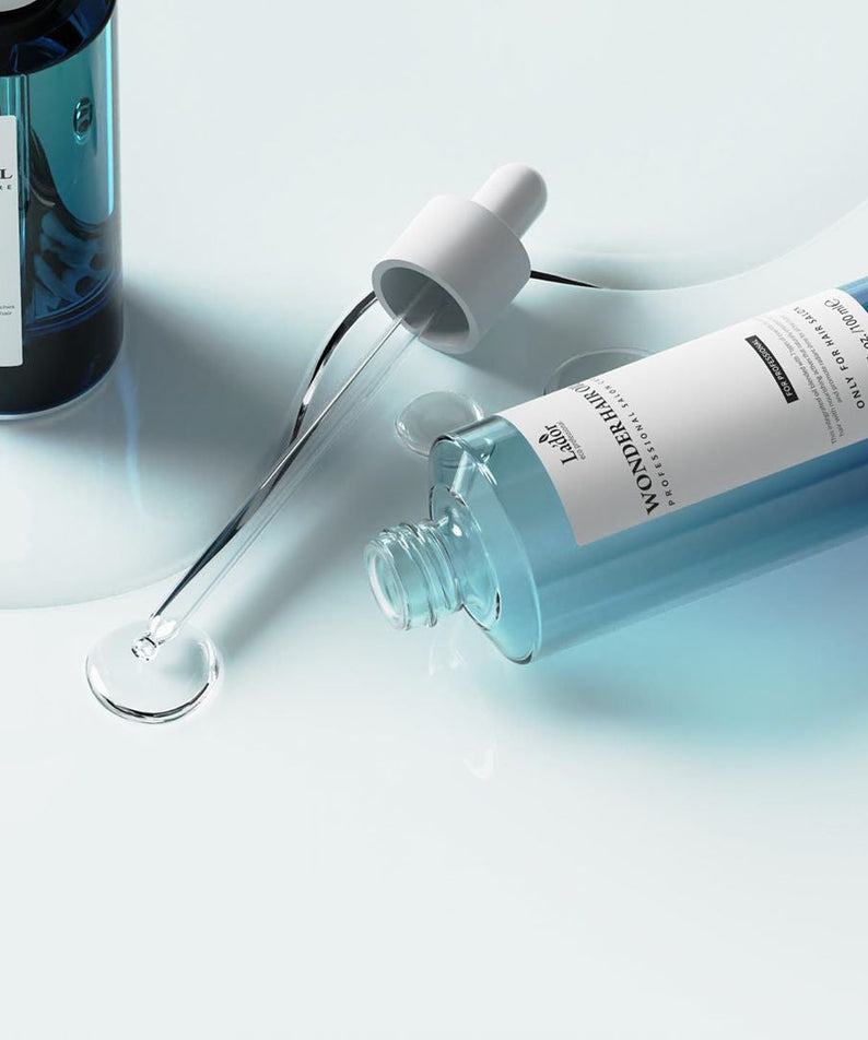 LADOR Wonder Hair Moisture Oil 100ml bottle with dropper on light background.