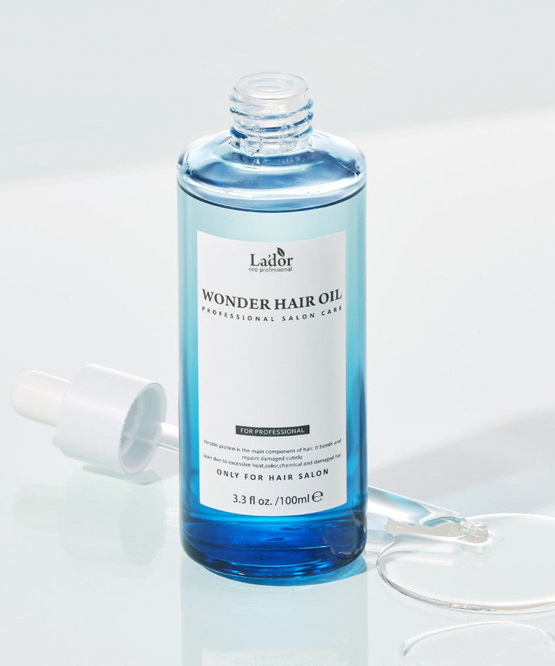 LADOR Wonder Hair Moisture Oil 100ml bottle with dropper, professional salon care for ultimate moisturization.