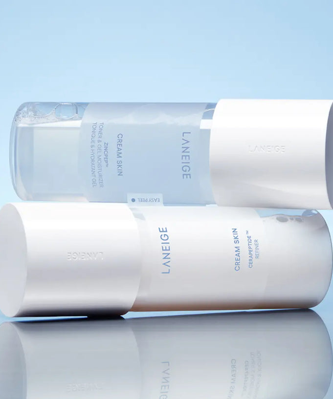 LANEIGE NEW Gel Cream Skin 170ml bottles stacked on a blue reflective surface, showcasing the sleek minimalist design.