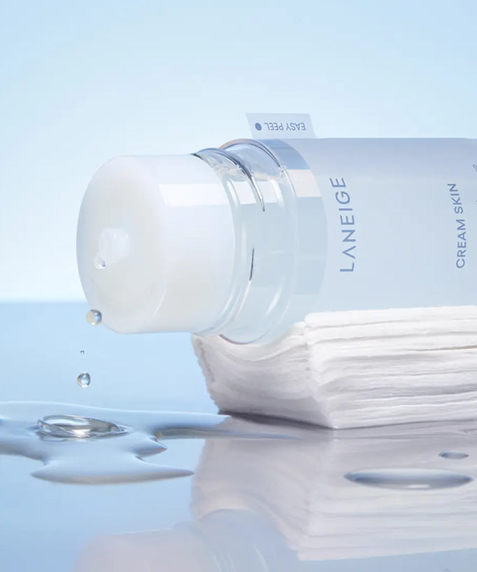 LANEIGE NEW Gel Cream Skin 170ml bottle with drops, showcasing its hydrating texture on a stack of cotton pads, perfect for skincare.